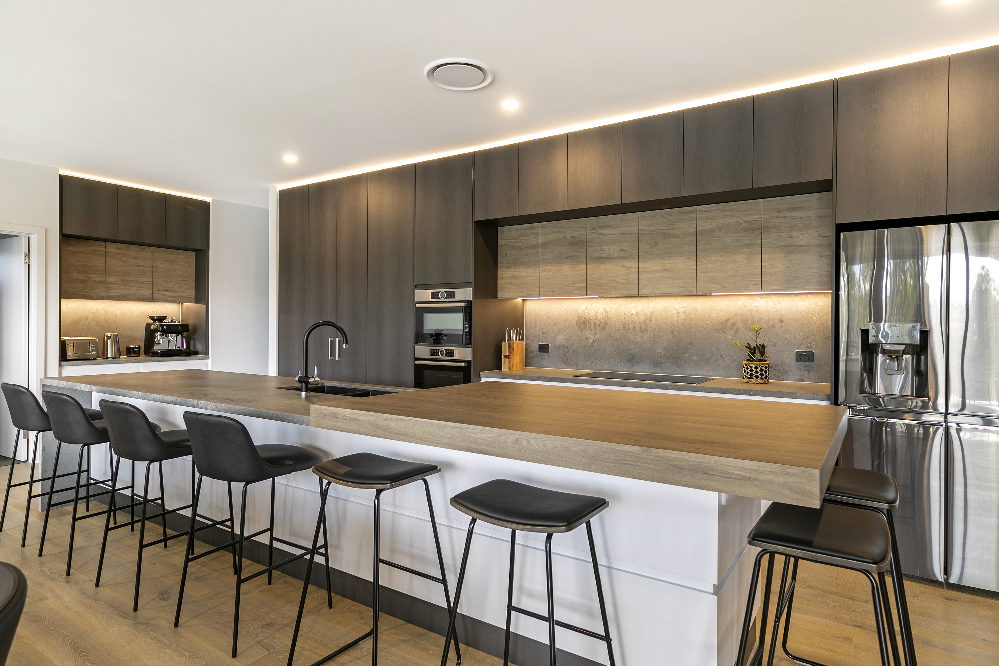 Adelaide kitchen renovation with white shaker cabinetry, marble benchtop and brass pendants in golden-hour light