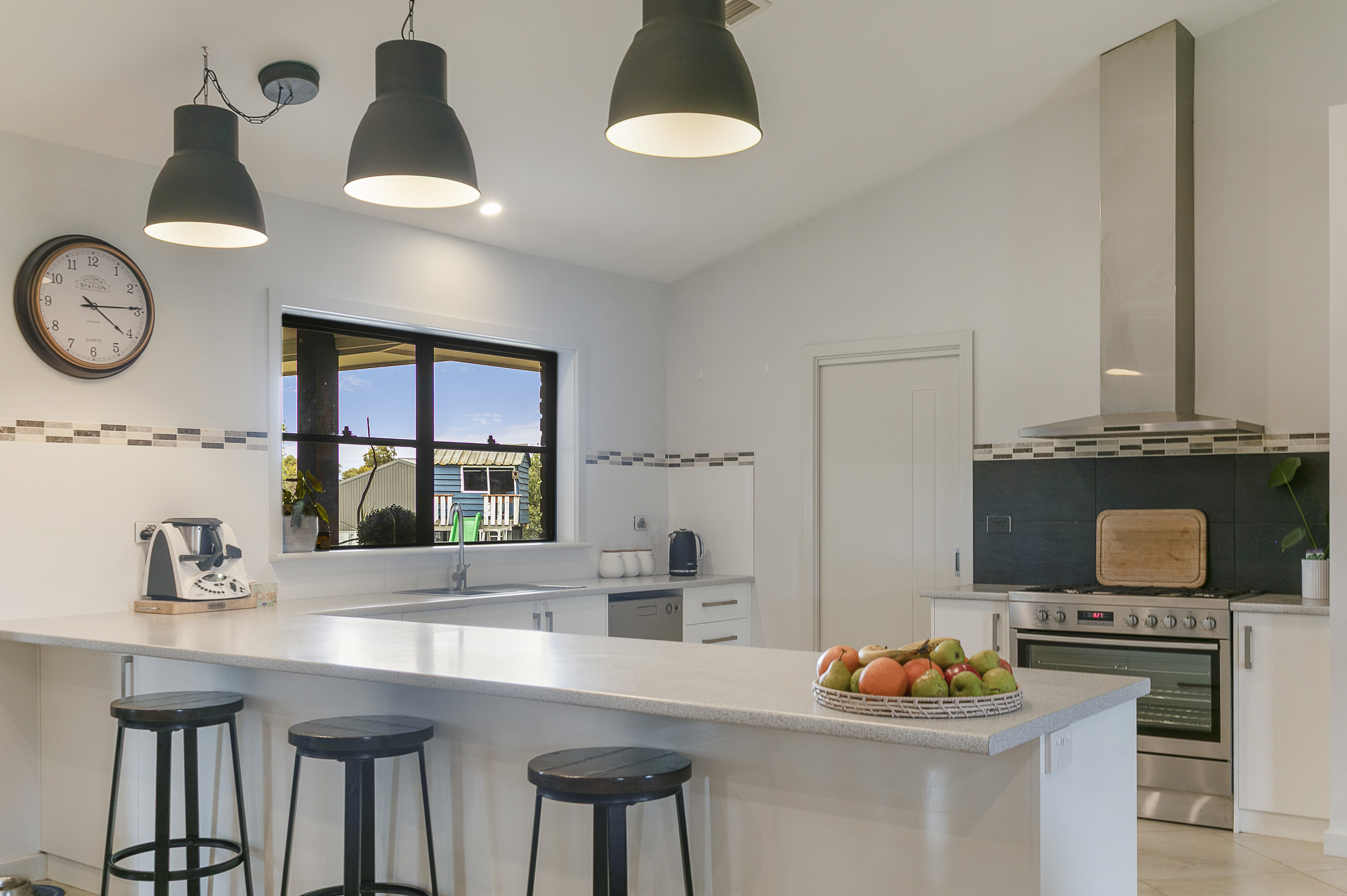 Adelaide laundry renovation with stone benchtop, full-height cabinetry and integrated drying rack in white shaker