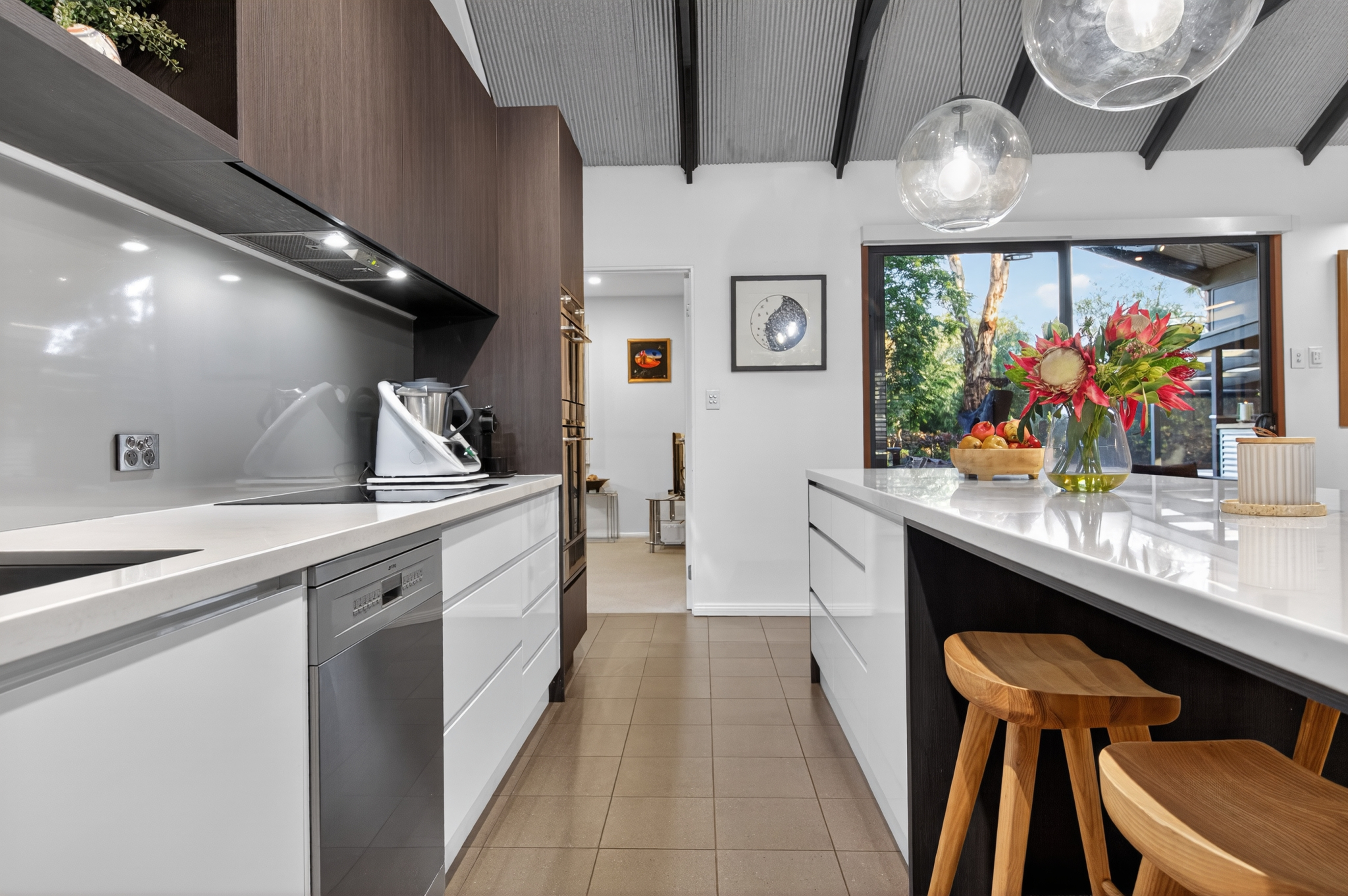 Adelaide outdoor kitchen with built-in BBQ, porcelain stone benchtop and pergola integration in alfresco area