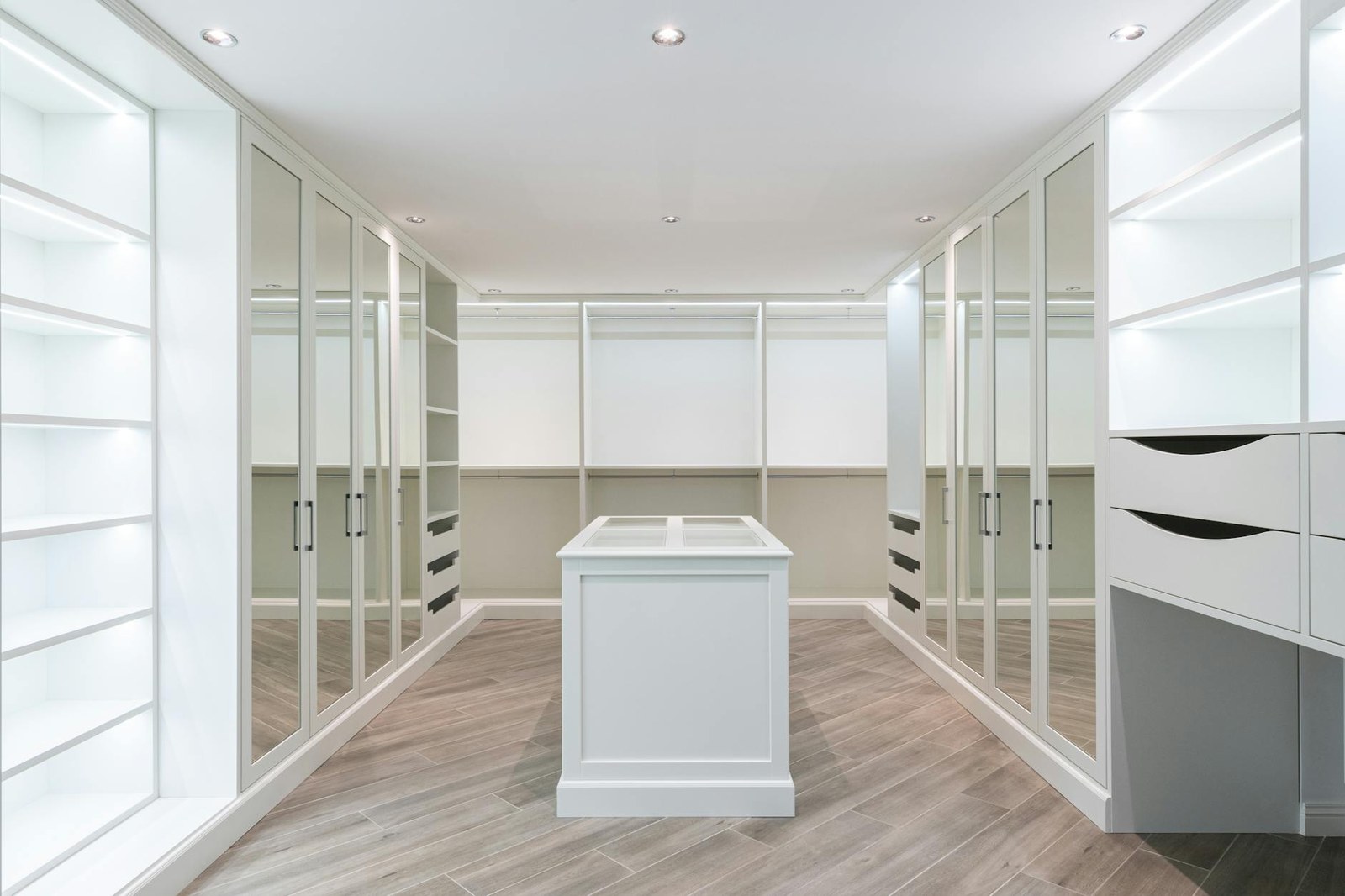 Custom walk-in wardrobe with island drawer unit and full-height hanging in an Adelaide home